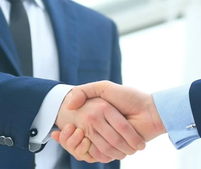 Two businessmen in suits shaking hands